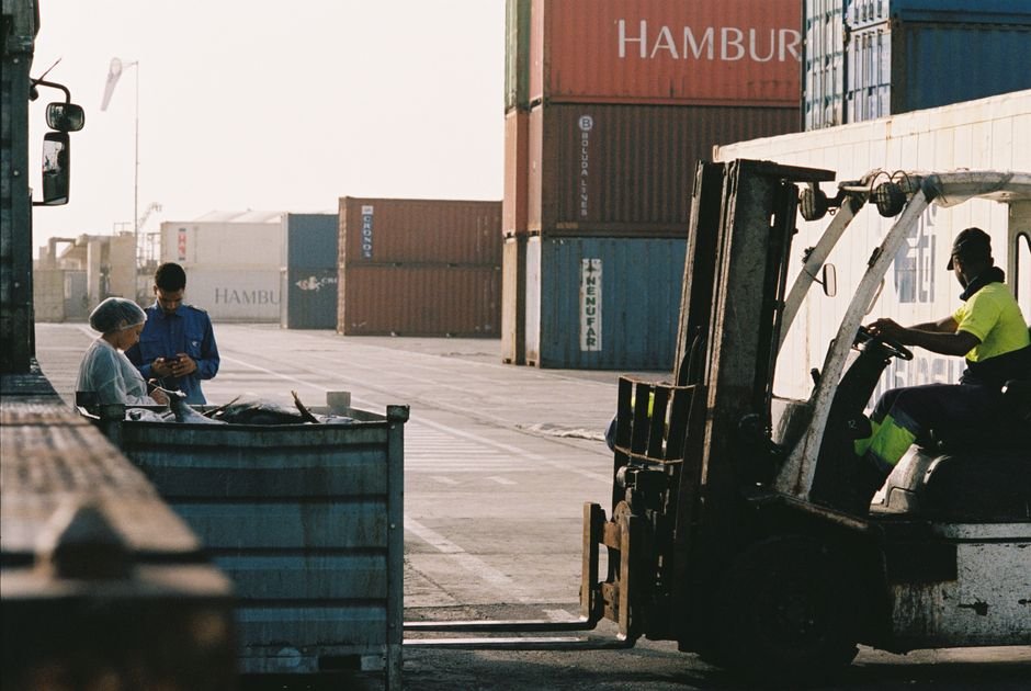 Forklift moving wrapped commercial pallets at a China warehouse for China to Belgium commercial pallet shipping
